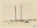 Image of Bowdoin in winter quarters with snowmobile alongside